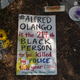 A sign lies on the ground at the site where an unarmed black man, Alfred Olango, 38, had been shot by police earlier that week on Sept. 29, 2016, in El Cajon, Calif.
